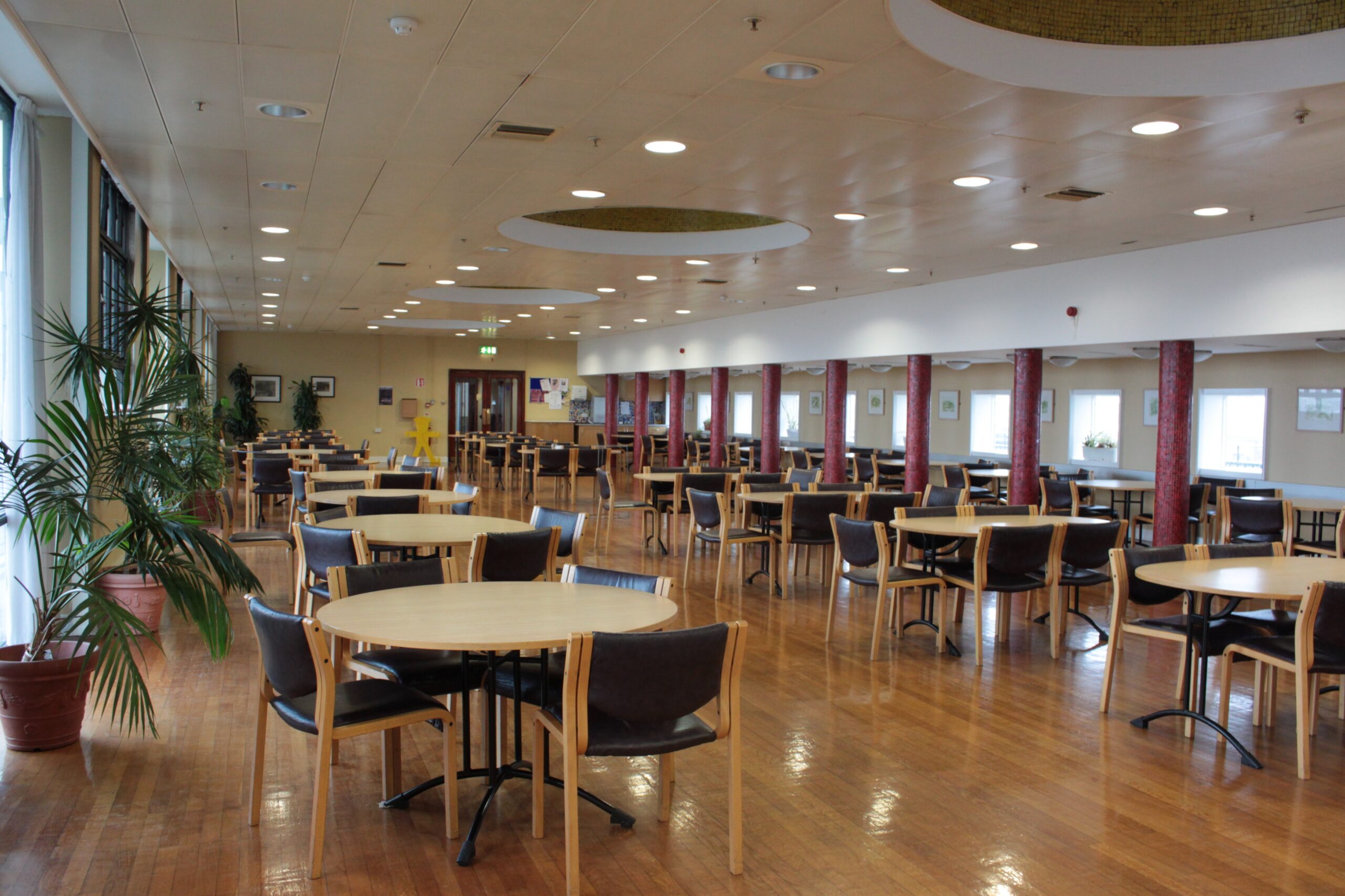 Building interior showing cafeteria a spacious area with tables and chairs