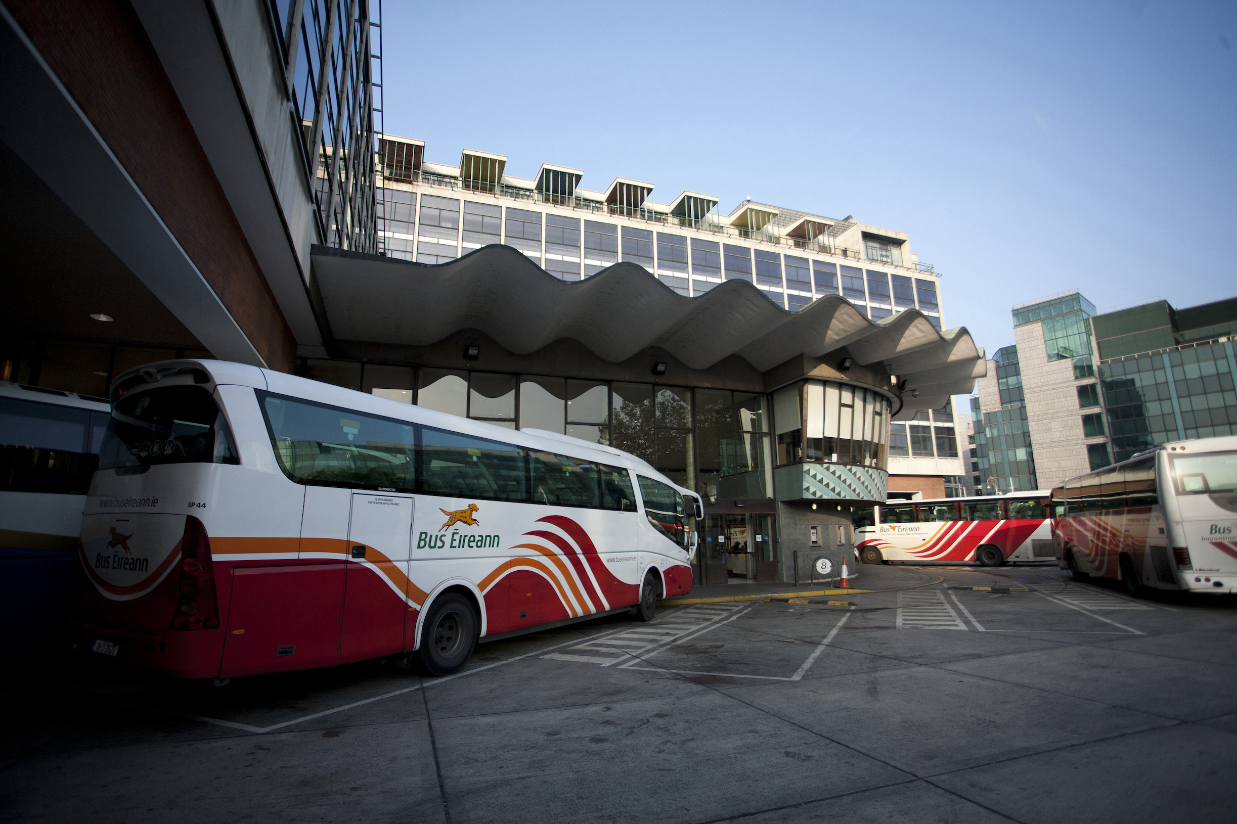 Buses parking area with Modernist building on the background