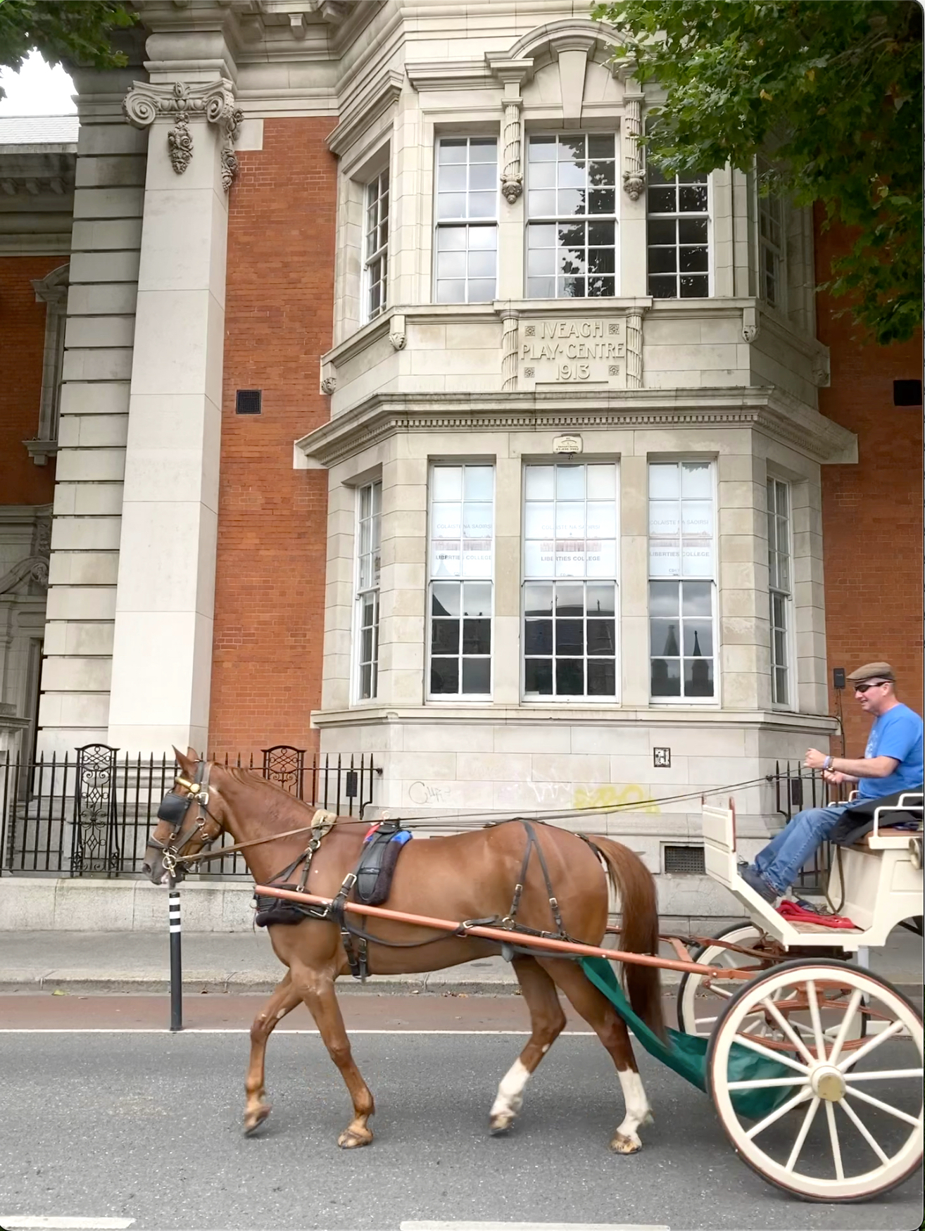 Exterior of building with horse carriage on the foreground