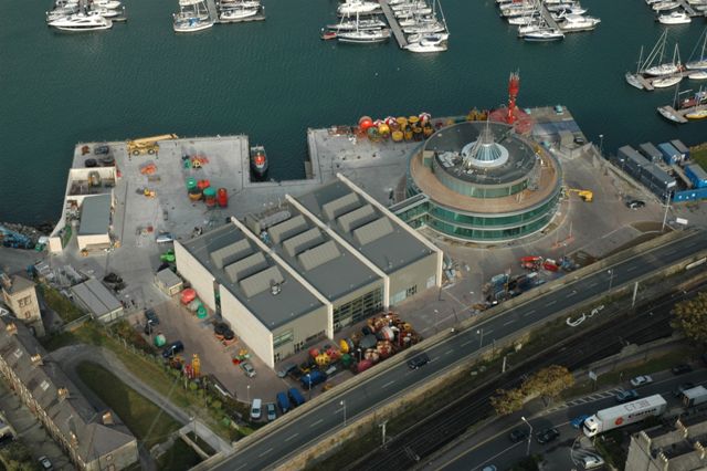 Aerial view of harbour site with boats on the background