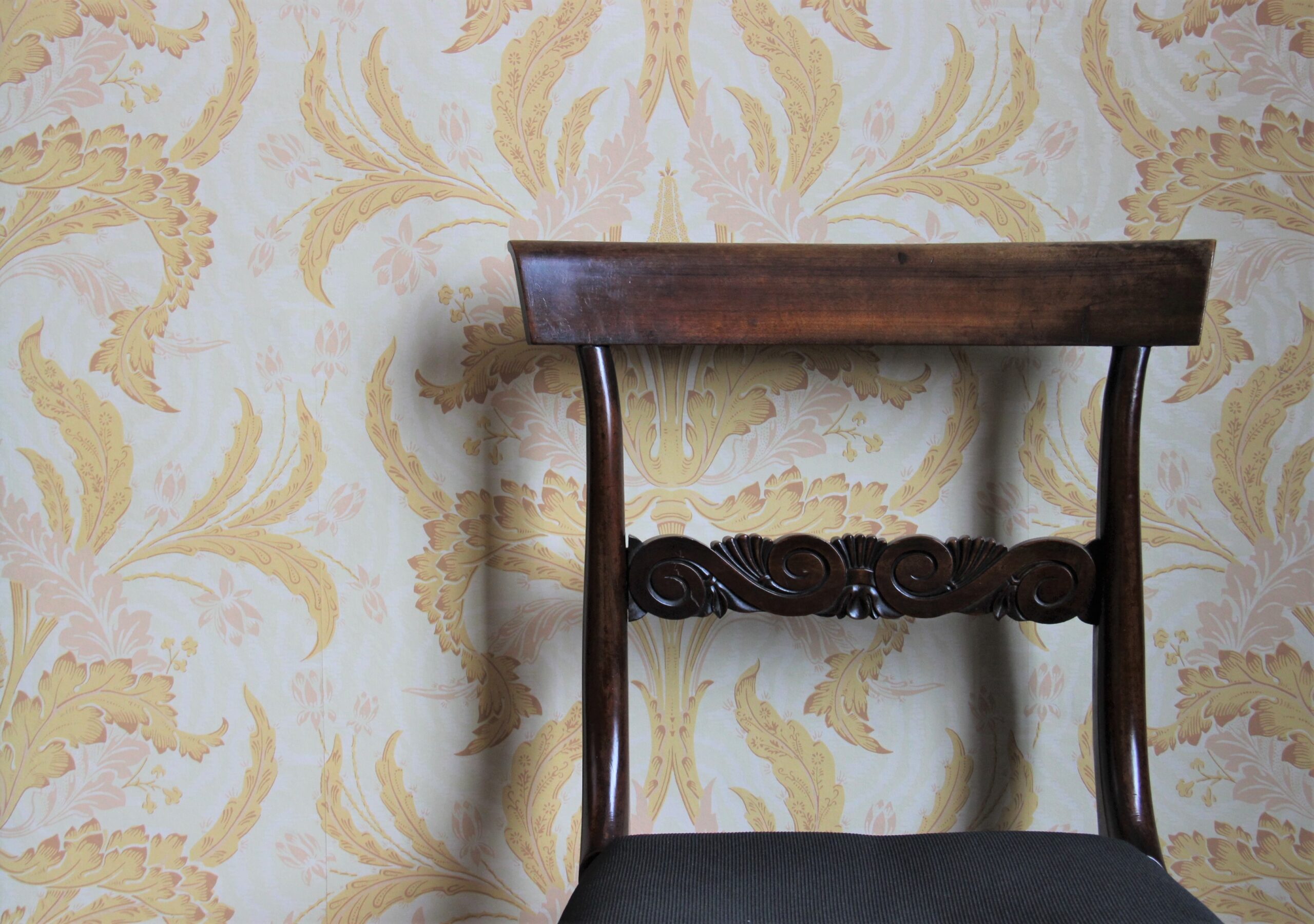 Traditional Irish Wallpaper and wooden chair on the foreground