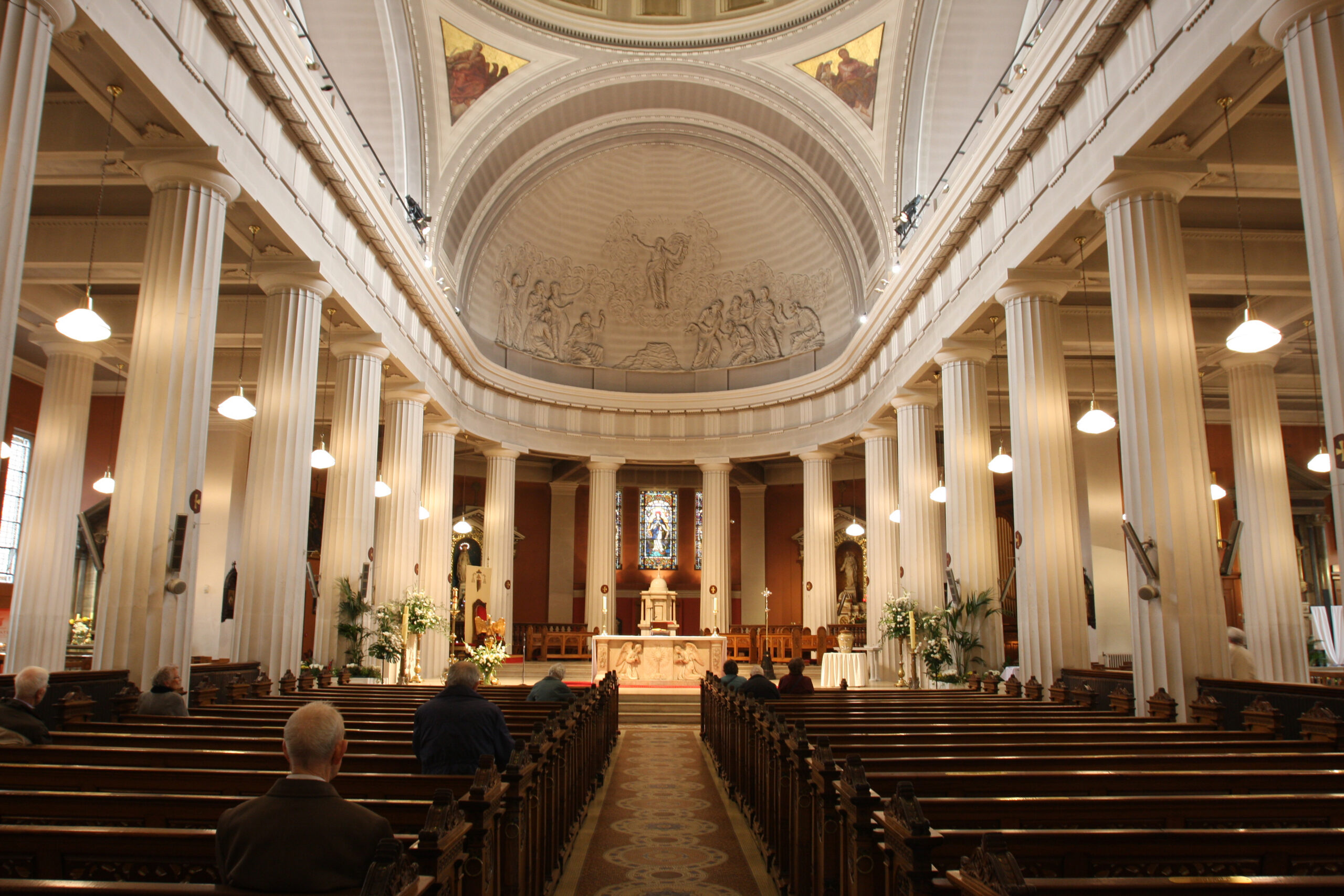 Inside view of cathedral with white columns and round ceiling