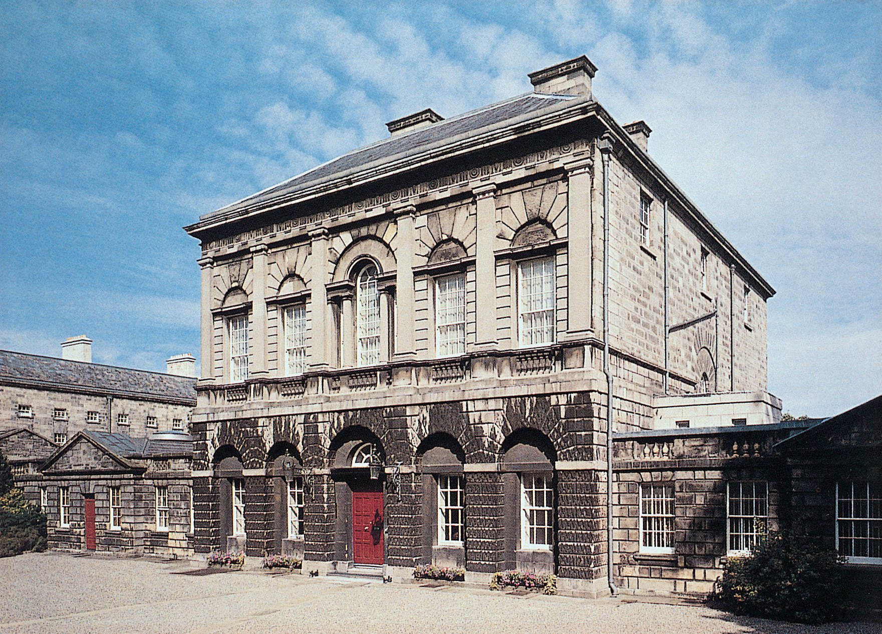 Photograph of the front façade of the Provost's House. The Provost's House is a five-bay, two-storey house with seven-bay single-storey wings on each side.