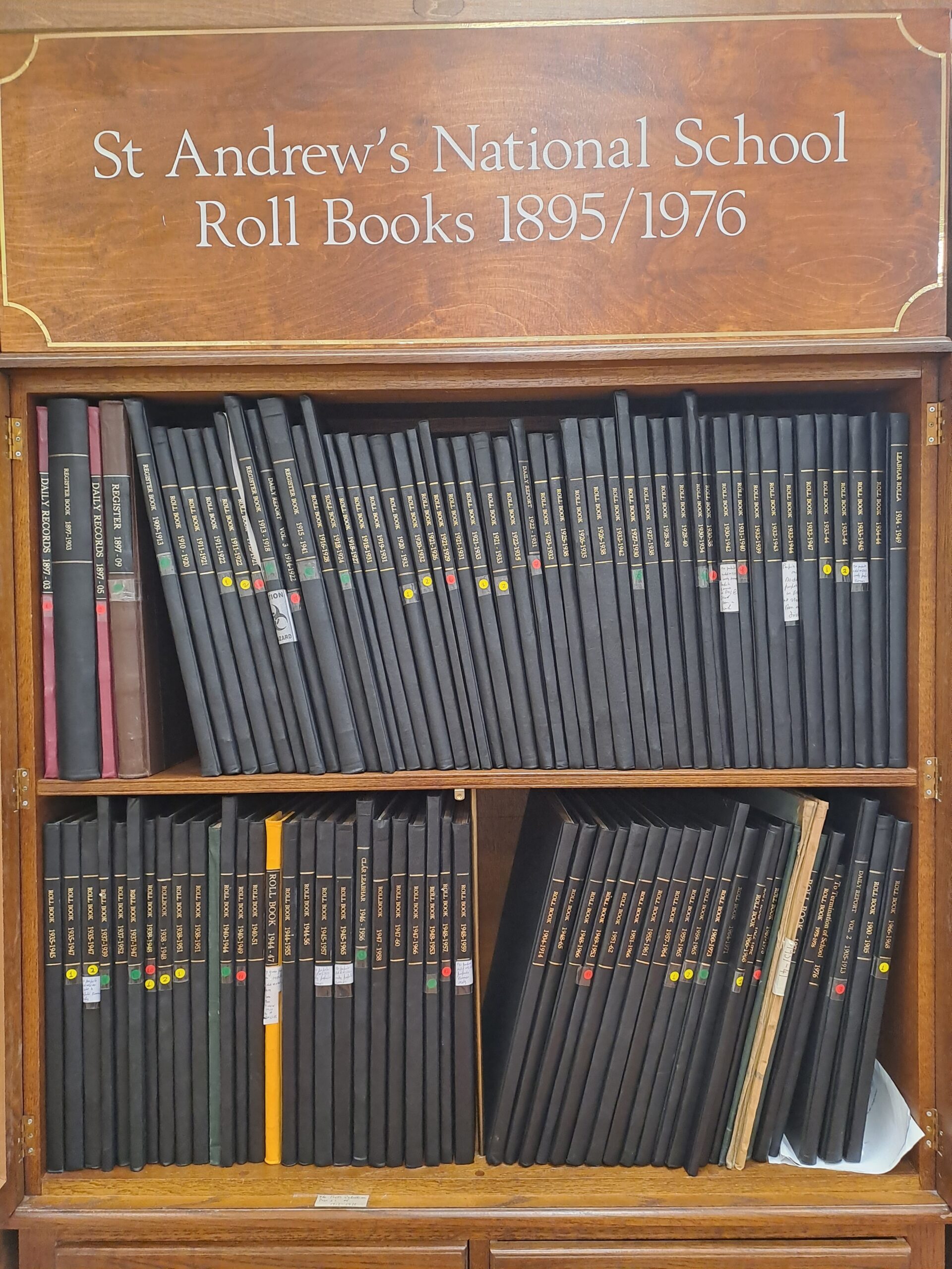 Wooden book shelf with set of Roll books from 1895-1976