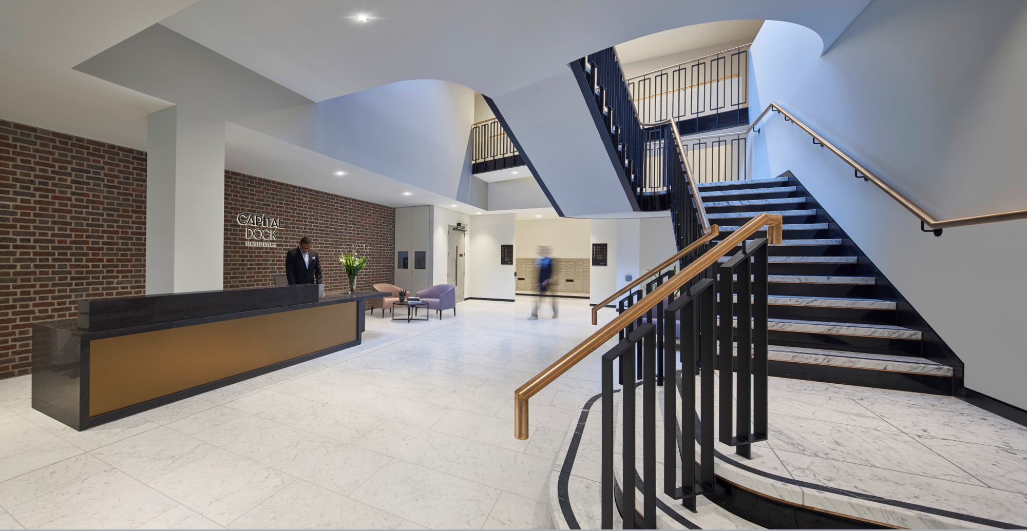 Foyer of apartment building with reception area and stairs