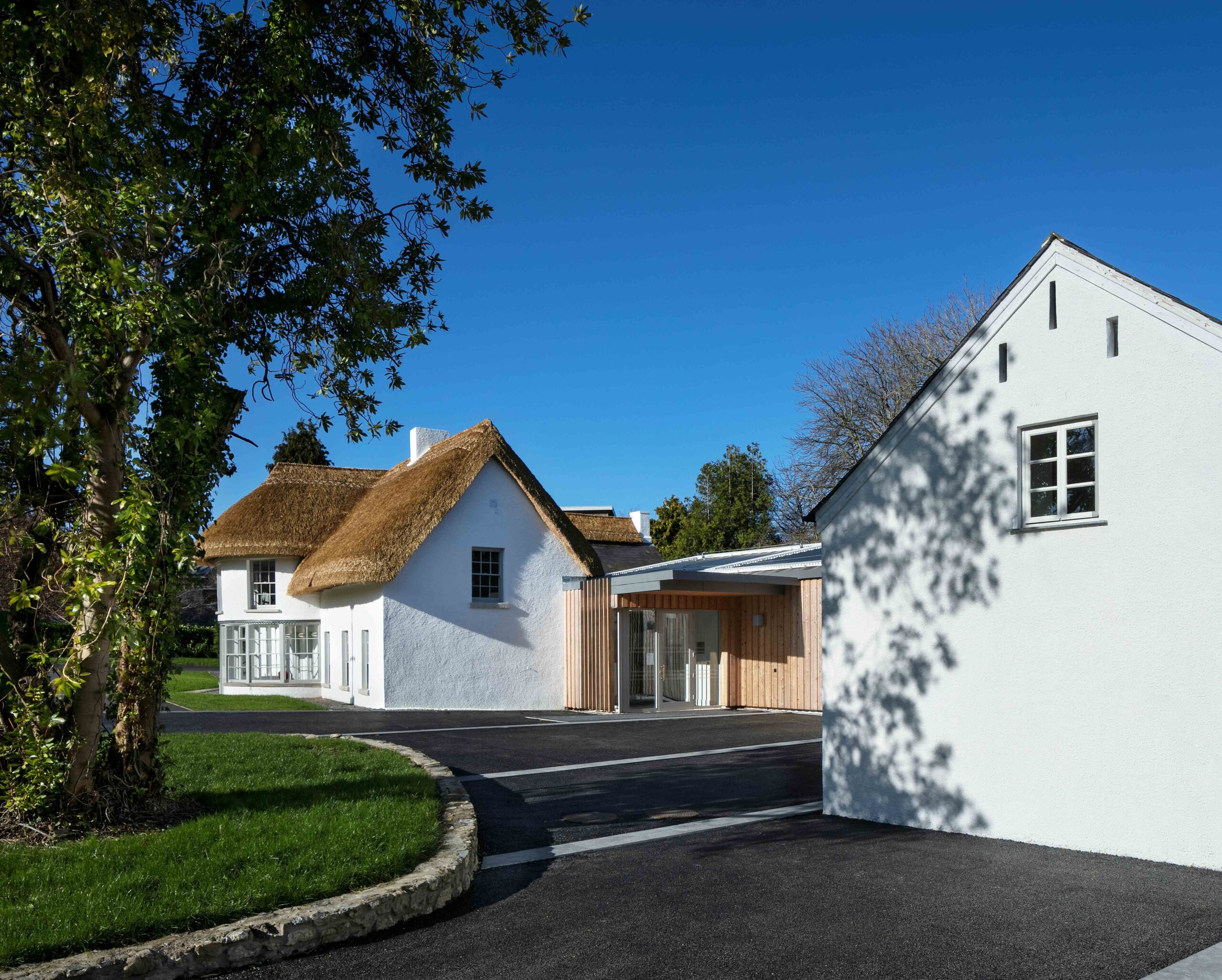Timber clad extension to restored cottage building