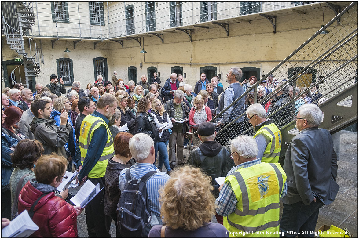 Group participating in singing tour on a building courtyard