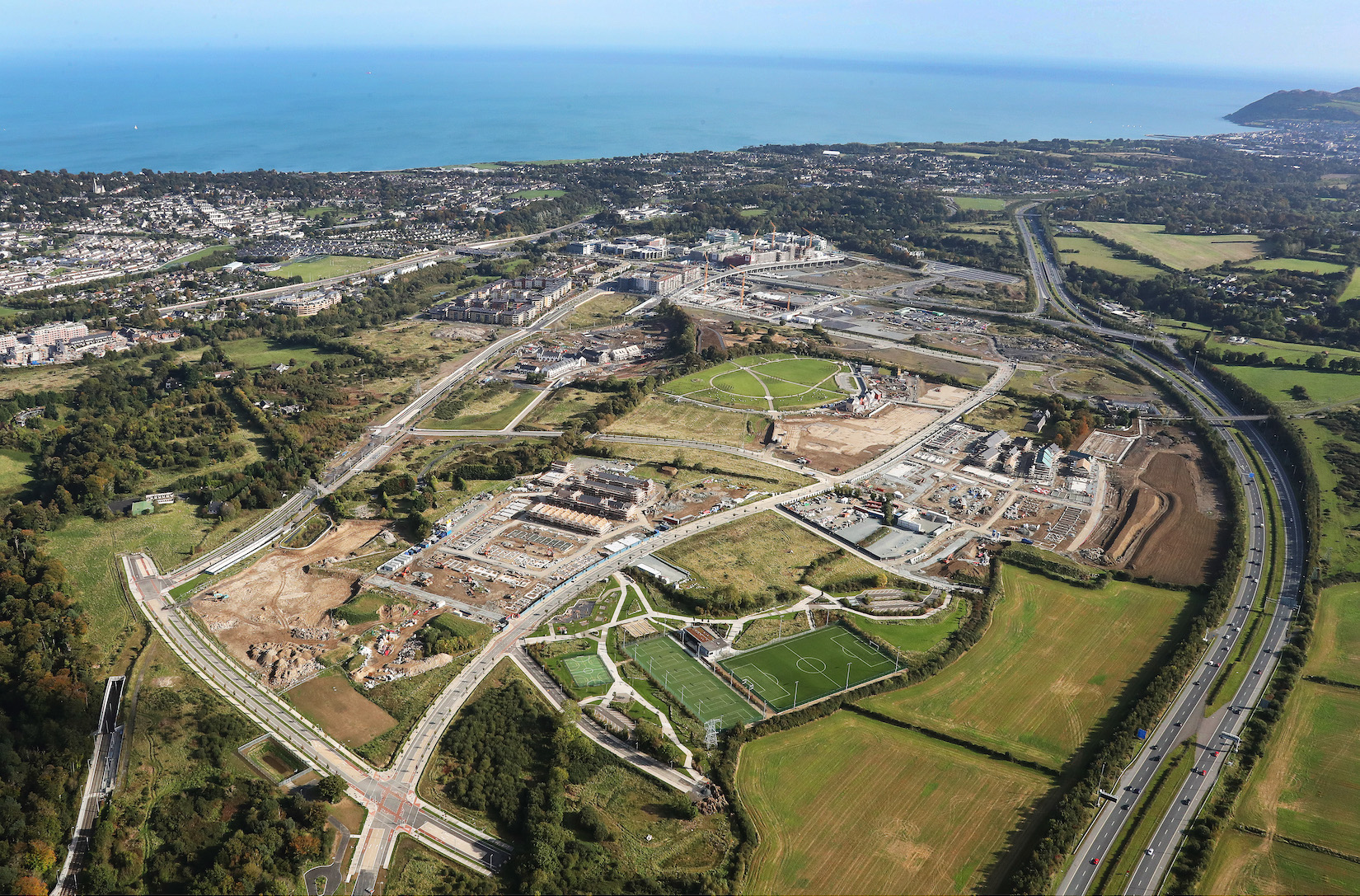 Aerial view of residential development and green fields