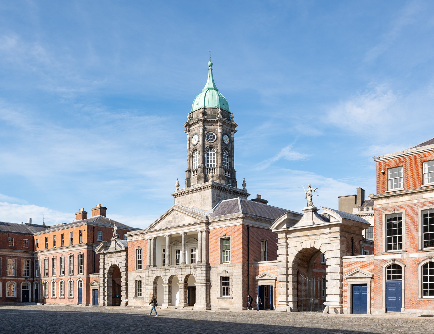 Outside view of Dublin Castle, a 13th century building with two archway entrances and round tower