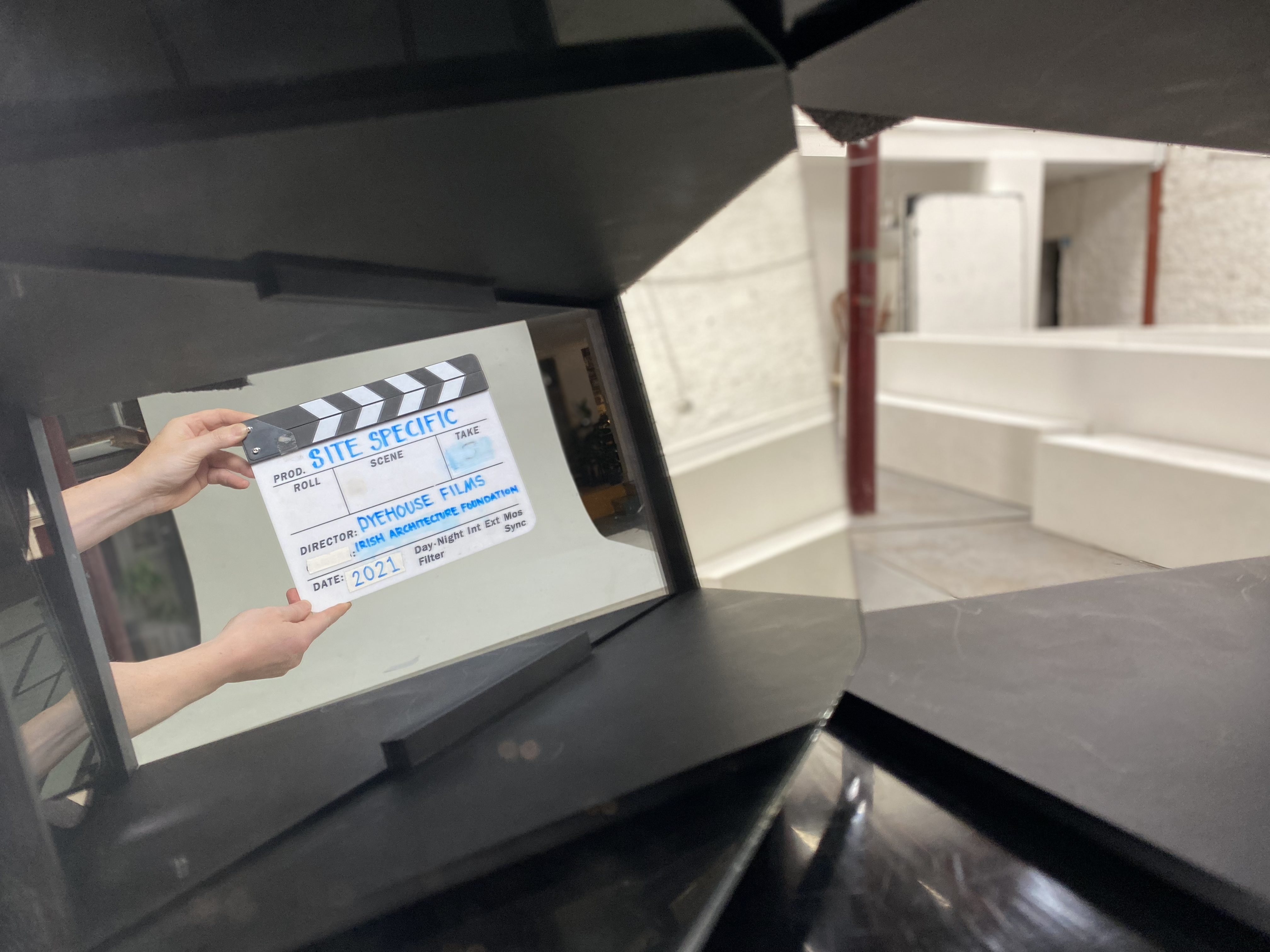 Men hands holding a clapperboard with the words Site Specific, Dyehouse Films, Irish Architecture Foundation, 2021