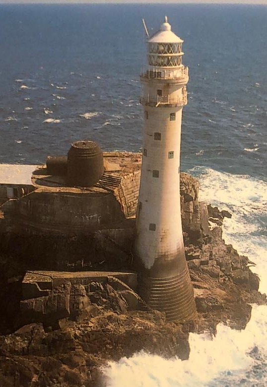 Aerial view of Fastnet lighthouse with waves crashing into the rocks